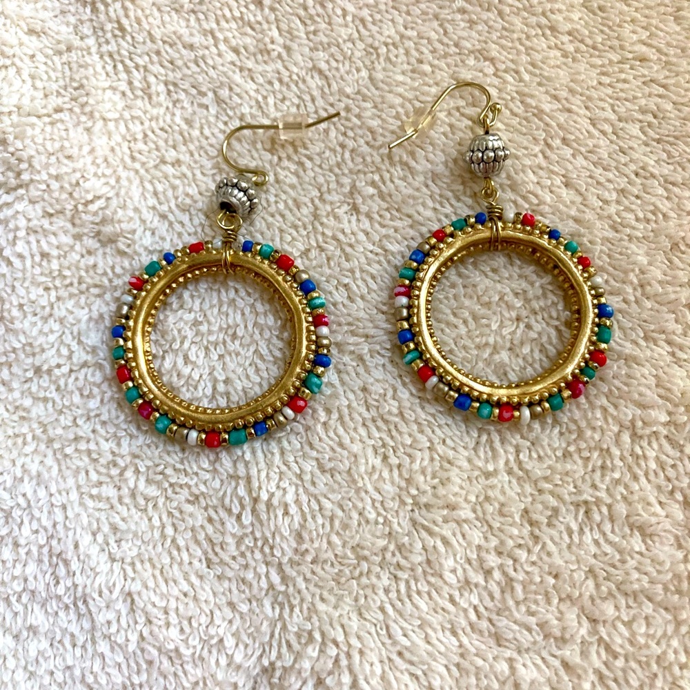 Shine this holiday season with these colorful beaded hoops in gold and silver..
